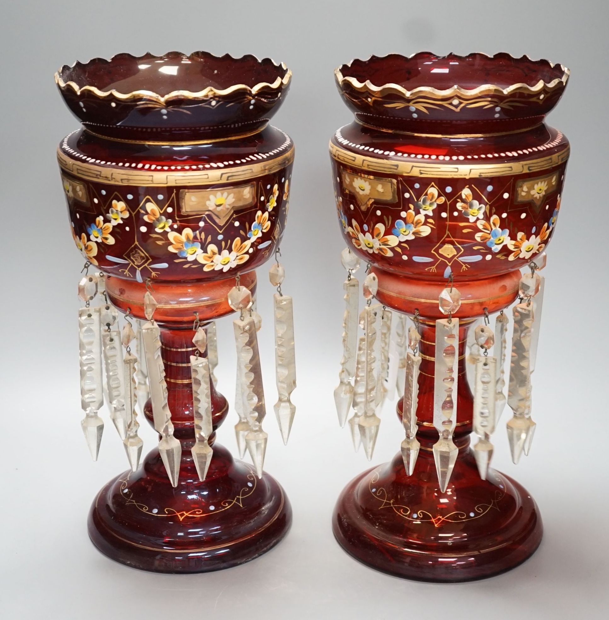 A pair of late 19th century ruby glass and enamel lustres - 36cm high